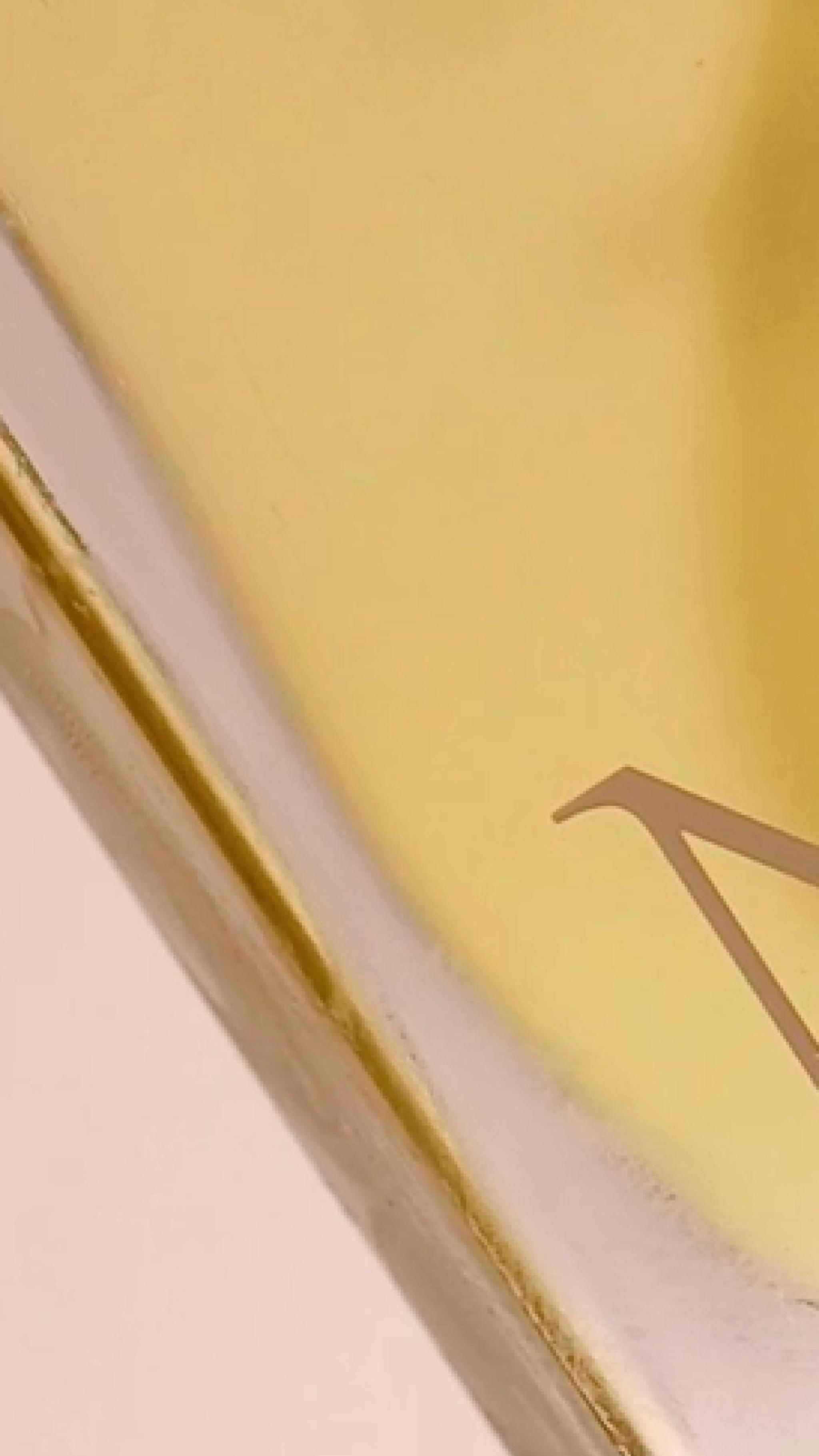 Close-up of Nerra perfume bottle with golden oil reflections